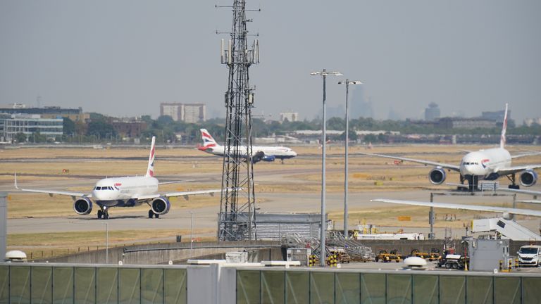 British Airways planes taxi through the heat haze at Heathrow Airport, London, where the hottest day on record in the UK has been recorded with the temperature reaching 40.2C according to provisional Met Office figures. Picture date: Tuesday July 19, 2022.
