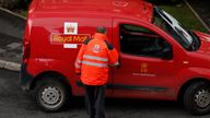 A Royal Mail postal worker returns to his van near Manchester northern England, April 7, 2016. REUTERS/Phil Noble