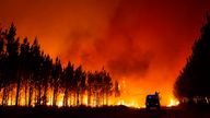 This photo provided by the fire brigade of the Gironde region SDIS 33, (Departmental fire and rescue service 33) shows firefighters tackling a blaze near Saint-Magne, south of Bordeaux, southwestern France, Wednesday, Aug. 10, 2022. (SDIS 33 via AP)