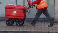 File photo dated 25/01/18 of a postman delivering letters in Woking, Surrey, as Royal Mail has said it will need to hike prices and slash costs to offset soaring inflation amid an "uncertain" outlook for the economy as it posted a rise in annual earnings.
