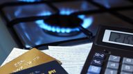 bank cards and a calculator on the background of a burning plate