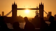 Commuters cross London Bridge at sunrise in London, Britain, February 23, 2022. REUTERS/Tom Nicholson
