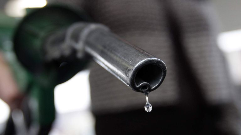 A customer fuels her car with unleaded petrol at a Morrisons supermarket in Coalville