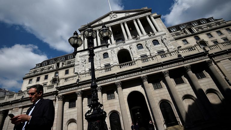 FILE PHOTO: A man stands outside the Bank of England in the City of London, Britain April 19, 2017. Sterling basked in the glow of a six-month high following Tuesday's surprise news of a snap UK election. REUTERS/Hannah McKay/File Photo
