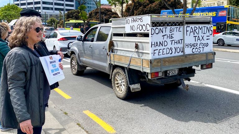 A farm vehicle drives through central Wellington during a protest on climate change proposals to make New Zealand farmers pay for greenhouse gas emissions, Thursday, Oct. 20, 2022. New Zealand farmers drove their tractors to towns around New Zealand on Thursday in protest at a proposed new tax on cow burps and other farm greenhouse gas emissions. (Nick James/New Zealand Herald via AP)