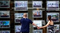 A couple view properties for sale in an estate agents window in London, Britain August 22, 2016.  Picture taken August 22, 2016. REUTERS/Peter Nicholls