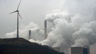 A wind turbine overlooks the E.ON coal-fired power station in Gelsenkirchen, Germany, Monday, Dec. 1, 2014. Sweeping change in the electricity business and the rise of renewable energy are behind German utility E.ON's decision to spin off its conventional power plants ... and create two companies that can each focus on what it does best. E.ON CEO Johannes Teyssen said Monday that conventional power generation will remain indispensable but that a 