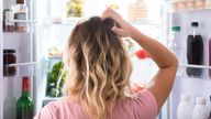 A woman looking inside a fridge