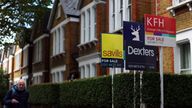 A man walks past houses ‘For Sale’ in a residential street in London, Britain, September 27, 2022. REUTERS/Hannah McKay    