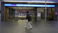 A man walks past the closed shutters at the entrance to King's Cross station in central London, during a strike by members of the Rail, Maritime and Transport union (RMT) and Unite, in a long-running dispute over jobs and pensions. The strike by transport workers in London is expected to cause travel chaos with limited services on the Tube. Picture date: Thursday November 10, 2022.