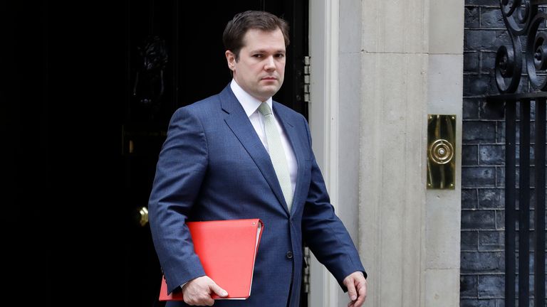 Britain's Housing Secretary Robert Jenrick leaves Downing Street after a meeting in London, Wednesday, March 18, 2020. For most people, the new coronavirus causes only mild or moderate symptoms, such as fever and cough. For some, especially older adults and people with existing health problems, it can cause more severe illness, including pneumonia. (AP Photo/Kirsty Wigglesworth)