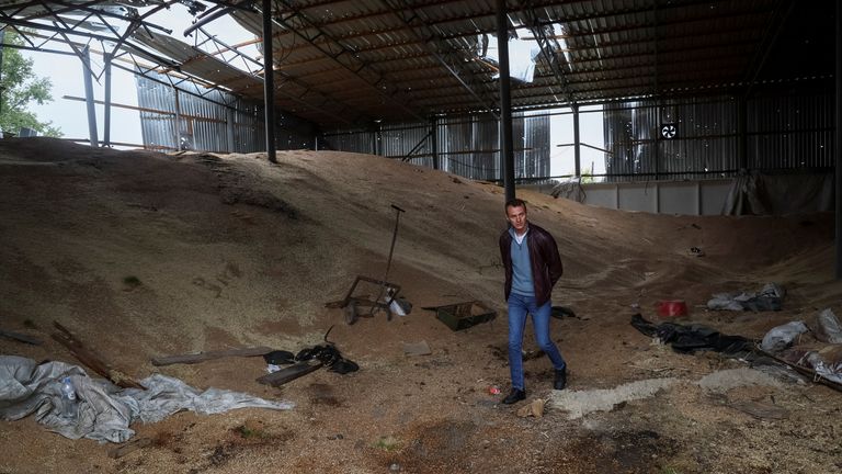 Vitali Orlov walks inside his destroyed grain silos, amid Russia's attack on Ukraine, in the village of Nova Husarivka, recently liberated by Ukrainian Armed Forces, in Kharkiv region, Ukraine September 15, 2022. REUTERS/Gleb Garanich
