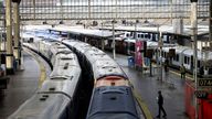 FILE PHOTO: A view of trains on the platform at Waterloo Station as a station worker stands nearby, on the first day of national rail strike in London, Britain, June 21, 2022. REUTERS/Henry Nicholls//File Photo