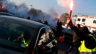 A demonstrator holds a flare as hundreds of drivers block the access with their cars at Porte Maillot in Paris, Thursday, Dec. 15, 2016. The protest targeted U.S. based Uber, and included Uber drivers unhappy with new working conditions, and drivers for other companies who say their livelihoods are threatened by Uber's activities.(AP Photo/Francois Mori)


