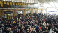 Passengers wait at the barriers at King's Cross station in London following a strike by members of the Rail, Maritime and Transport union (RMT), in a long-running dispute over jobs and pensions. 