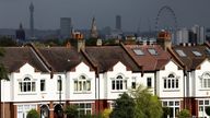 FILE PHOTO: A person jogs past a row of residential housing in south London, Britain, August 6, 2021. REUTERS/Henry Nicholls/File Photo