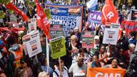 Protesters hold various trade union banners, signs and placards in support of rail workers during the rally outside King's Cross Station 