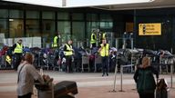 Airport workers stand next to lines of passenger luggage arranged outside Terminal 2 at Heathrow Airport in London, Britain, June 19, 2022. REUTERS/Henry Nicholls