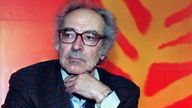 Swiss director Jean-Luc Godard strikes a pensive pose moments before the start of a press conference, May 10 as the 50th Cannes Film Festival continues .