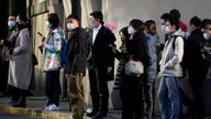 People wearing face masks wait at a traffic light to cross a street, as coronavirus disease (COVID-19) outbreaks continue in Shanghai, China, December 7, 2022. REUTERS/Aly Song
