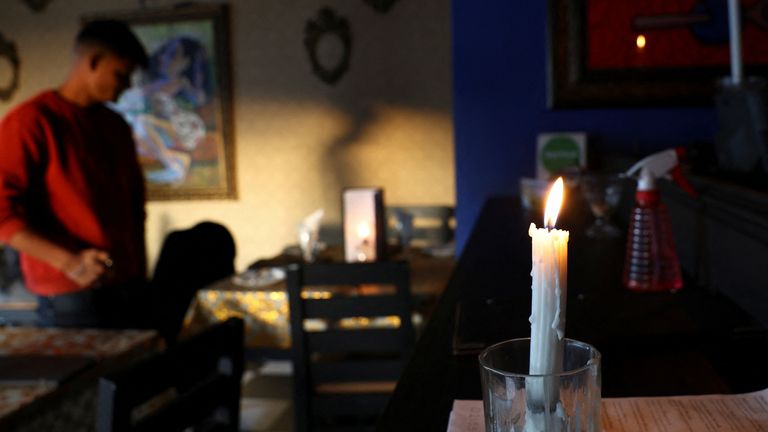 A restaurant uses candles due to South Africa's struggling power utility Eskom regular power cuts - called 'load-shedding' - because of ageing coal-fired power stations, in Cape Town, South Africa, September 20, 2022. REUTERS/Esa Alexander
