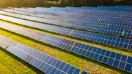 Solar power farm in the evening, fields of West Sussex, UK.