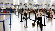 Workers prepare to delimit the Ryanair information desk during a cabin crew strike, at Malaga-Costa del Sol Airport, in Malaga, Spain, July 1, 2022. REUTERS/Jon Nazca
