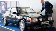 Silverstone Auctions' classic car specialist Arwel Richards polishes the 1985 Ford Escort RS Turbo previously owned by Diana, Princess of Wales, on display at the Silverstone Race Circuit near Towcester, Northamptonshire, before it goes under the hammer on Saturday at Silverstone Classics. Picture date: Friday August 26, 2022.

