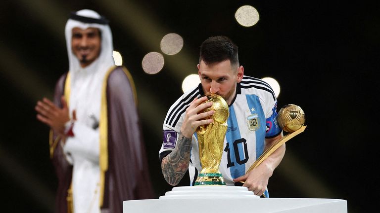 Argentina's Lionel Messi kisses the World Cup trophy after collecting the Golden Boot award