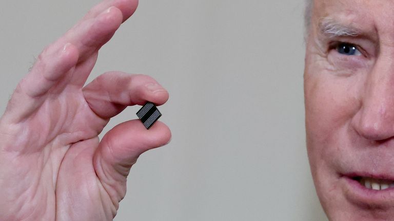 FILE PHOTO: U.S. President Joe Biden holds a semiconductor chip as he speaks prior to signing an executive order, aimed at addressing a global semiconductor chip shortage, in the State Dining Room at the White House in Washington, U.S., February 24, 2021. REUTERS/Jonathan Ernst/File Photo