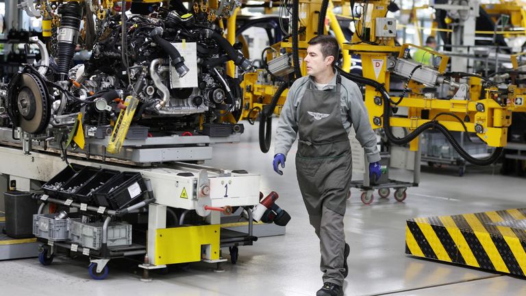 A staff member works on an engine block inside the Bentley factory in Crewe, Britain, December 7, 2022. REUTERS/Phil Noble