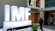 Attendees walk inside an atrium at the 2022 Annual Meetings of the International Monetary Fund and the World Bank Group, Monday, Oct. 10, 2022, in Washington. (AP Photo/Patrick Semansky)