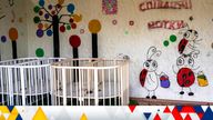 Empty cribs at a playhouse in the courtyard of Kherson regional children's home in Kherson, southern Ukraine, 
Pic:AP