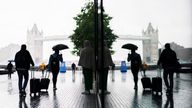 People shelter from the rain beneath umbrellas  in Southwark, south London. Picture date: Monday July 24, 2023. PA Photo.  Photo credit should read: Jordan Pettitt/PA Wire