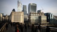 People walk over London Bridge during morning rush hour, with City of London financial district in the background, in London, Britain, February 10, 2023. REUTERS/Henry Nicholls