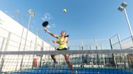 Woman playing padle tennis in court 