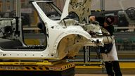 An employee works on a 2013 Mini at BMW's plant in Oxford, southern England November 18, 2013. BMW unveiled a more fuel efficient, third-generation version of its iconic Mini on Monday, as the world's biggest luxury carmaker looks to retain its leadership in the lucrative high-end compact car market. REUTERS/Suzanne Plunkett (BRITAIN - Tags: TRANSPORT BUSINESS)