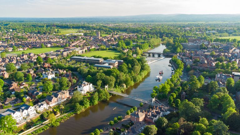 Aerial view of River Dee in Chester at dusk including Queens Park Bridge and The Old Dee Bridge, Cheshire, England, UK

