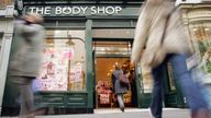 Shoppers walk into a Body Shop store in Covent Garden, central London, March 17, 2006.  Reuters