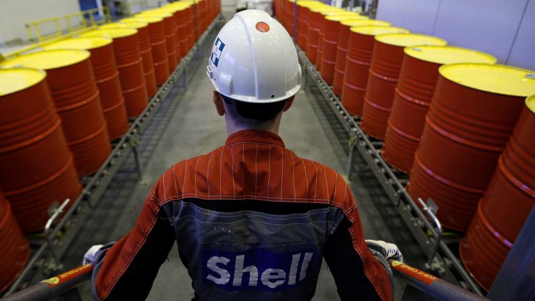 An employee stands in front of lines of oil barrels at Royal Dutch Shell Plc's lubricants blending plant in the town of Torzhok, north-west of Tver, November 7, 2014. Picture taken November 7, 2014. REUTERS/Sergei Karpukhin (RUSSIA - Tags: BUSINESS INDUSTRIAL)
