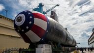 FILE PHOTO: The Virginia-class attack submarine Pre-commissioning Unit (PCU) John Warner (SSN 785) is moved to Newport News Shipbuilding's floating dry dock in preparation for the September 6 christening in Newport News, Virginia, U.S. August 31, 2014. To match Special Report CHINA-CYBER/CLOUDHOPPER U.S. Navy/John Whalen/Huntington Ingalls Industries/Handout via REUTERS ATTENTION EDITORS - THIS IMAGE WAS PROVIDED BY A THIRD PARTY./File Photo
