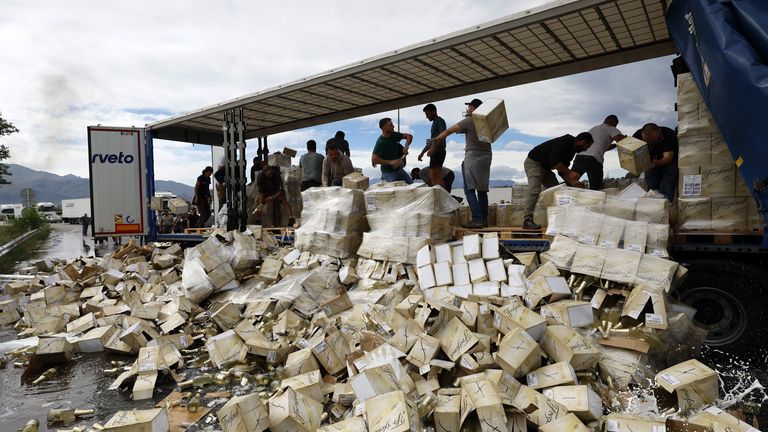 French winemakers destroy a shipment of Freixenet cava coming from Spain during a demonstration by the tollbooth in Le Boulou