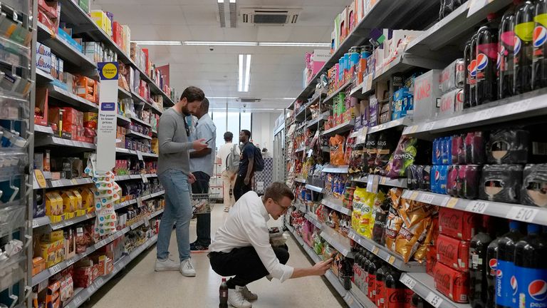 FILE - Shoppers buy food in a supermarket in London, Wednesday, Aug. 17, 2022. Official figures show that inflation in the U.K. has fallen to its lowest level since the immediate aftermath of Russia...s invasion of Ukraine which caused energy and food costs to surge. The Office for National Statistics said Wednesday that the consumer price index dropped to 8.7% in the year to April from 10.1% in March. (AP Photo/Frank Augstein, File)