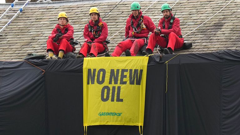 Greenpeace activists on the roof of Prime Minister Rishi Sunak's house in Richmond, North Yorkshire after covering it in black fabric in protest at his backing for expansion of North Sea oil and gas drilling. Picture date: Thursday August 3, 2023.