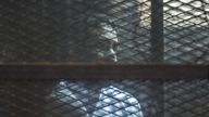 Prominent Egyptian activist Alaa Abd el-Fattah stands in a cage during a verdict hearing for 21 people over an unauthorized street protest in 2013, in a courtroom in Cairo, Egypt, Monday, Feb. 23, 2015. The court sentenced Abd el-Fattah, an icon of the country's 2011 revolt to five years in prison Monday, showing authorities' determination to continue to stifle dissent despite promises by its president to release 