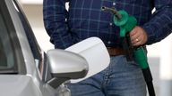 A man holds a petrol pump nozzle at a petrol station in London, Thursday, June 9, 2022.  