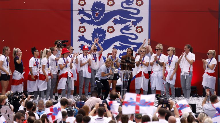 England head coach Sarina Wiegman lifts the trophy on stage during a fan celebration to commemorate England's historic UEFA Women's EURO 2022 triumph in Trafalgar Square, London. Picture date: Monday August 1, 2022.