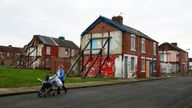 A woman pushes a pram IN Middlesbrough