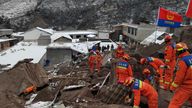 Rescuers search the site of the landslide. Pic: Xinhua via AP