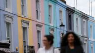 Pedestrians walk past a row of houses in London, Britain June 3, 2015. British house prices rose at their slowest annual rate in nearly two years in May, as growth continued to moderate after double-digit increases in the middle of 2014, figures from mortgage lender Nationwide showed on Wednesday. REUTERS/Suzanne Plunkett